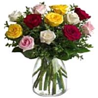 A colorful display of Red, Yellow, White, and Pink Roses. Twelve long stem Roses...