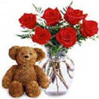 This charming arrangement of six long stem Red Roses in a Vase, along with a Ted...