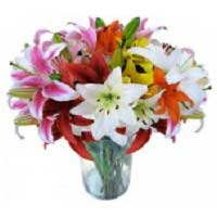 Give someone a surprise journey to the tropics with this charming vase overflowi...