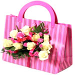 Beautiful arrangement of roses, greens, decorative elements  in handbag shaped b...