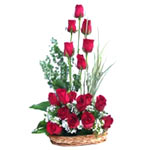 Delightful basket adorned with red roses decorated beautifully with lots of gree...