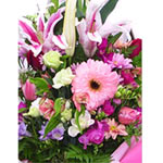 Roses, lilies, daisies, gerberas, alstroemerias and lisianthus arranged in a cer...