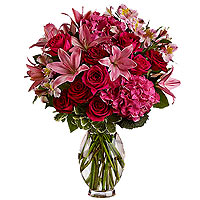 Passionate cerise pink roses, pink Asiatic lilies, hydrangeas and exotic alstroe...