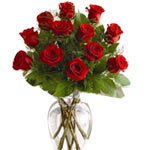 Beautiful red Roses arranged in a vase with assorted greenery.  <br/>Note:- Deli...