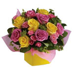 This stunning arrangement of pink and yellow roses...