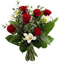 A classically inspired bouquet of red roses contra...