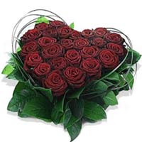 Lovely arrangement of red roses, combined with fresh greenery in the form of a h...
