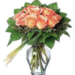 Peach Roses Arranged in a Beautiful Vase With a Collar of Rich Green Leaves and ...