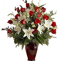 16 red roses, 3 white perfume lilies, match greenery, arrange in beautiful glass...