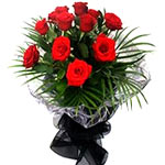 Beautifully wrapped bunch of  deep red roses deocrated beautifully with matching...