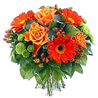 Colorful flowers in shades of orange and red make this bouquet a happy picture....