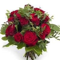 This eye-catching red rose bouquet kicks it up a notch with long tendrils of ivy...