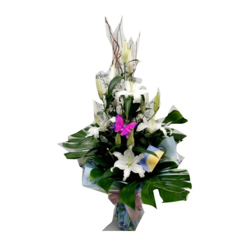 Fresh white tulips and lilies in a water vase. The...
