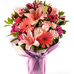 This attractive arrangement of Seasonal Flowers like Roses, lilies, daisies, ger...