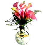 It consists of 8 white Lilies of the Nile in a small crystal vase with little me...