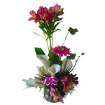 A fancy and colorful flower arrangement in a glass vase for that special someone...