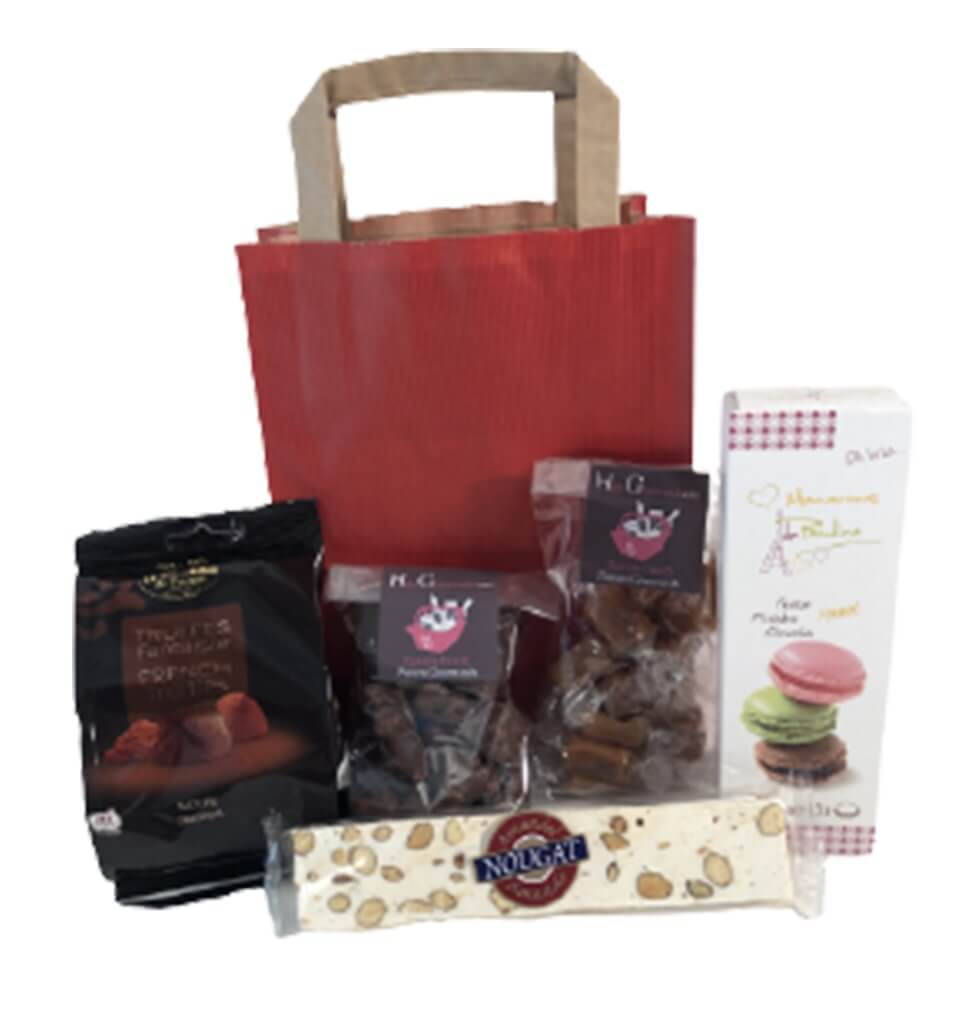 A gift bag filled with delicacies such as candy, c......  to foix