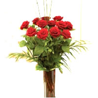 Bouquet of roses and exotic plants , arranged in an elegant vase for her to enjo...