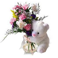 Cute Teddy Bear holding a romantic bouquet will te......  to kushva_florists.asp