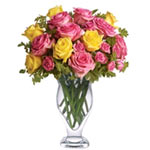 This Pink and  yellow y roses, berries and lush greens are perfectly arranged wi...