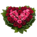 This beautiful arrangement of red and pink roses in heart shape will warm your r...